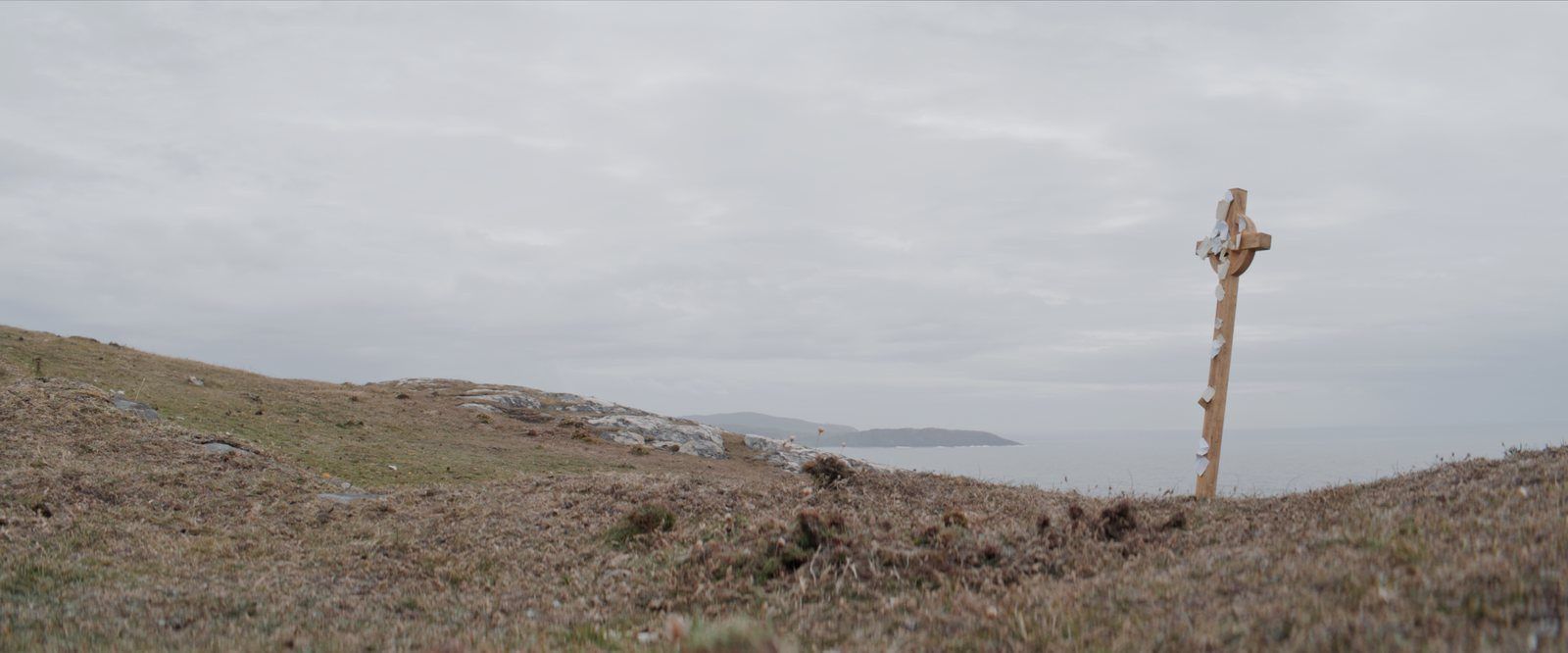 A wooden Celtic cross on a clifftop above the sea, West Cork