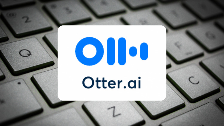 clouse-up a computer keyboard with the otter.ai logo in fron of it