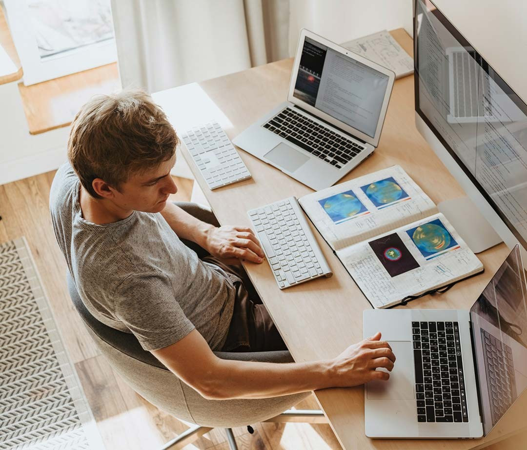 A man making and editing videos on a laptop computer.