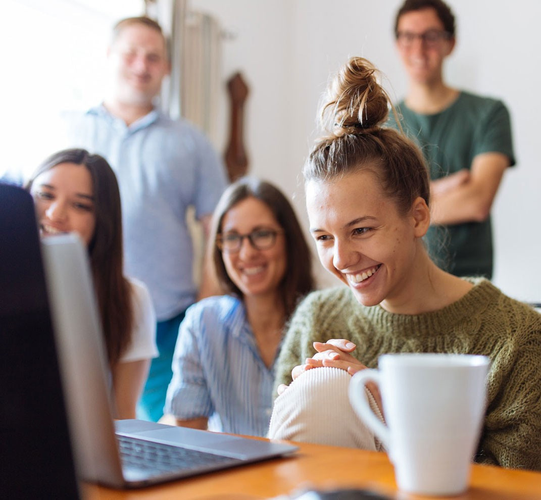 People enjoying an online video on a laptop.