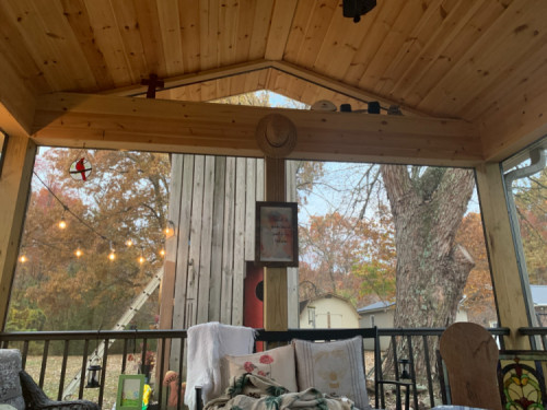 the view from the family's screened in porch. A rustic wood open viewed porch. From the porch you can see Corban's tree house.