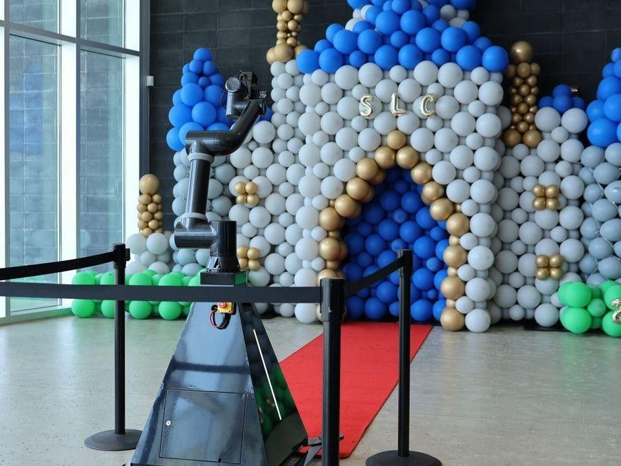 Glambot camera arm in front of a balloon castle backdrop