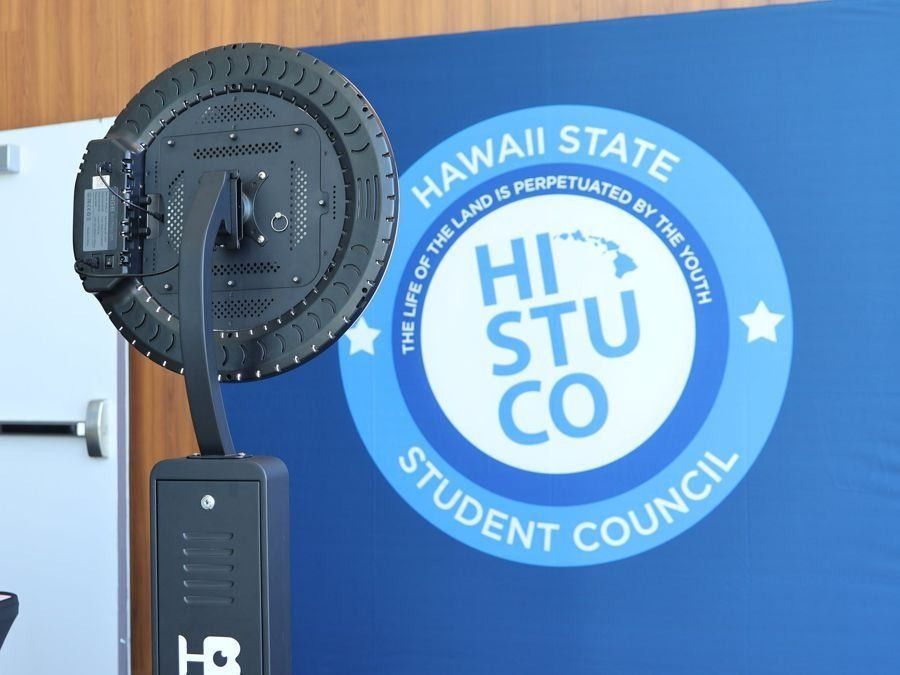 Printed Hawaii State Student Council backdrop beside a photo booth