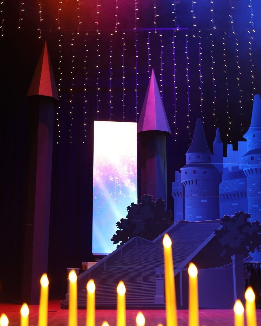 Castle stage set with candles and lit screen
