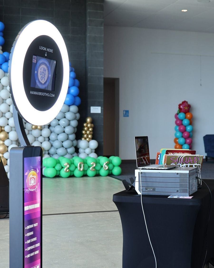 Ring-light photo booth beside a balloon wall
