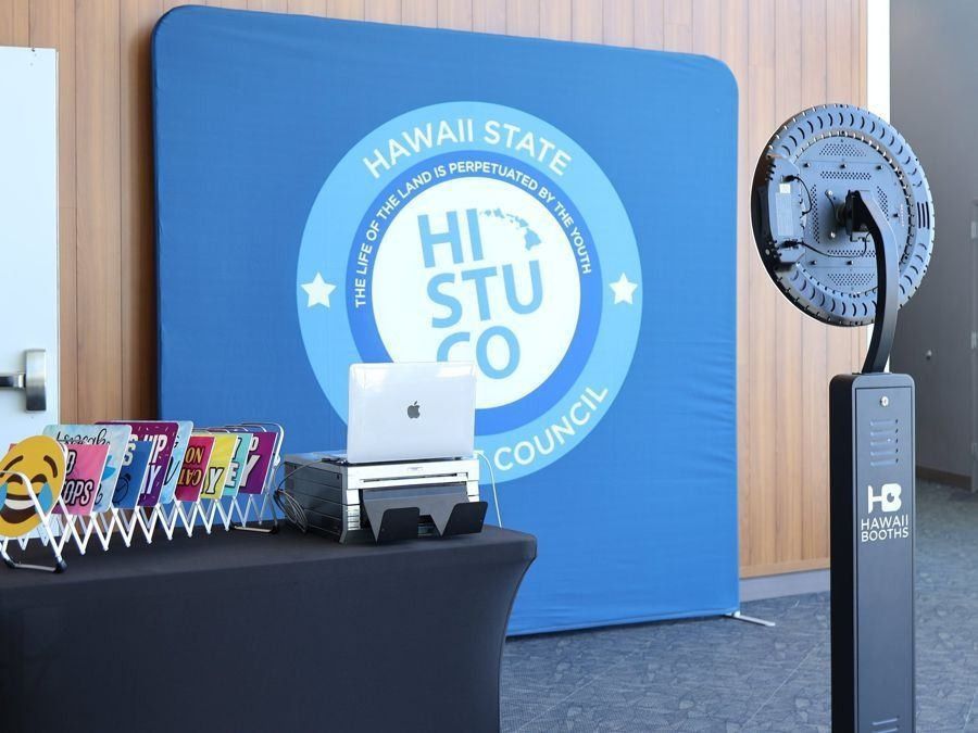 Photo booth setup with a printed student council backdrop