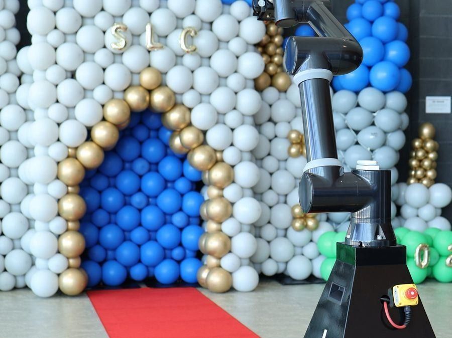 Glambot ready in front of a balloon castle