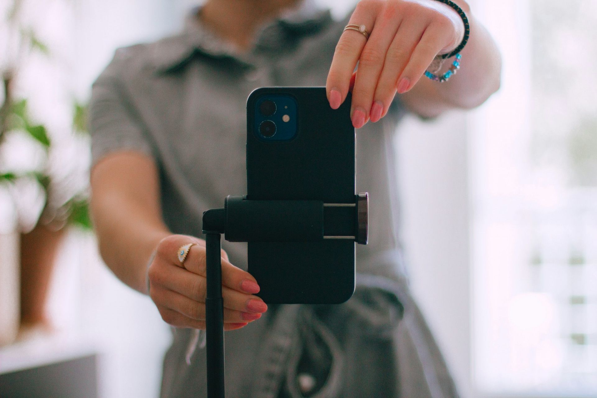 Phone mounted on a small tripod, ready to film social content
