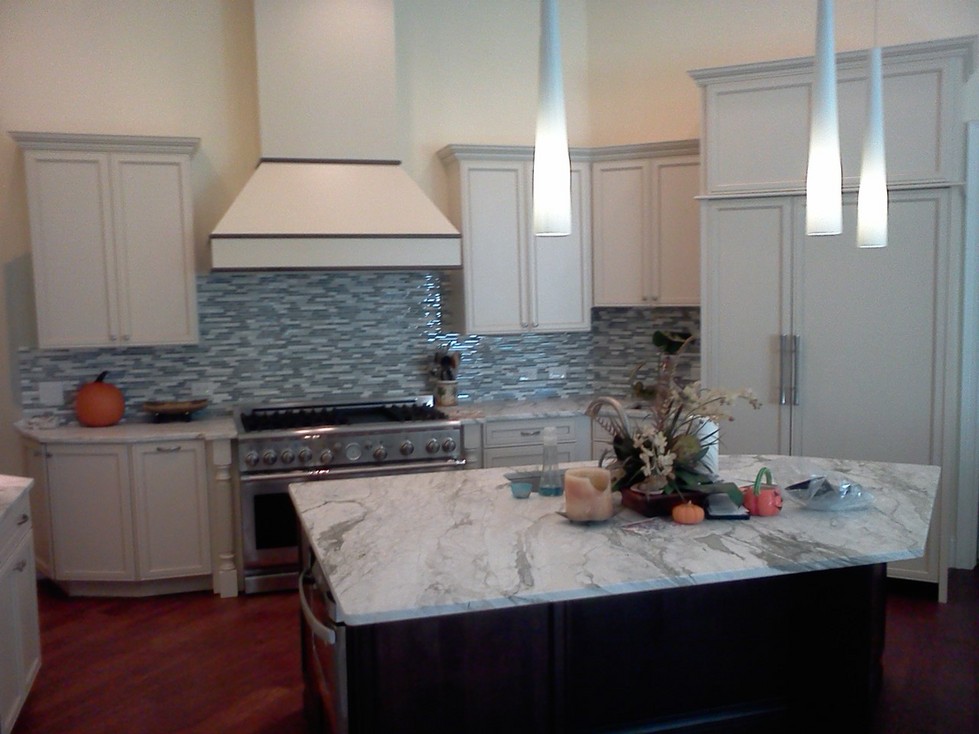 New kitchen with granite slab countertop and mosaic glass backsplash